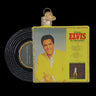 A Christmas ornament shaped like an Elvis Presley vinyl record, featuring a black record sleeve with gold glitter trim and a front cover photo of Elvis in a yellow suit against a black background.