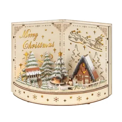 A Christmas-themed wooden diorama box with a curved base, featuring laser-cut scenes of snow-covered trees, cabins, stars, reindeer, and the words 'Merry Christmas' on a cream-colored panel.