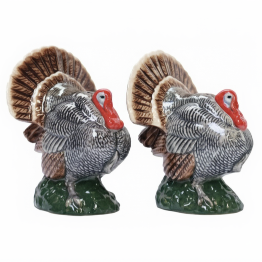 Two ceramic turkey figurines on a white background