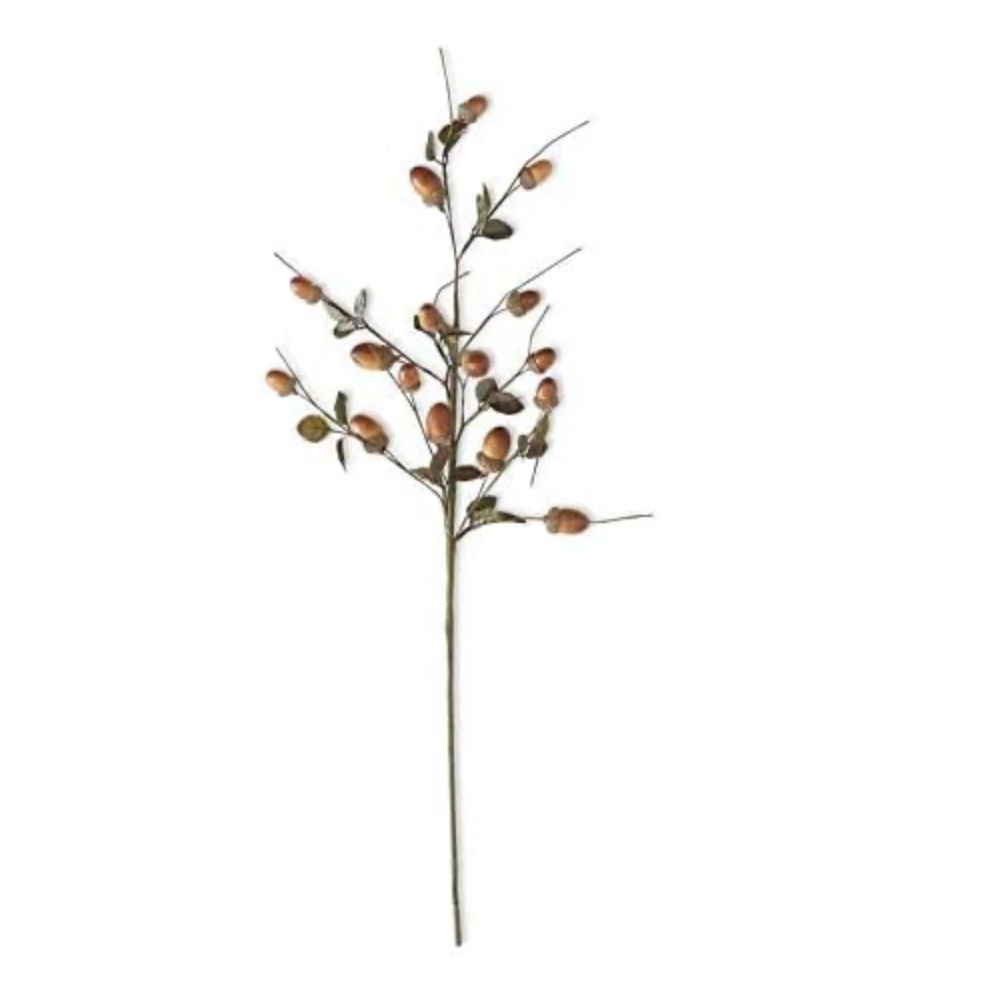 Artificial plant stem with acorn decorations on a white background