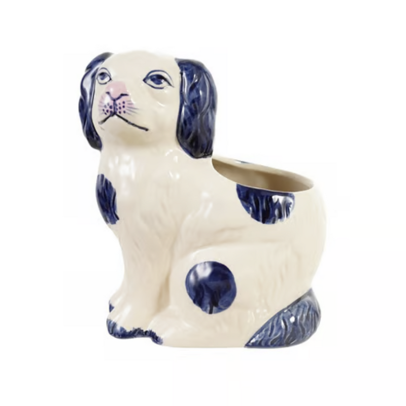 A ceramic dog-shaped planter with a cream-colored body and dark blue spotted details, shown against a plain white background.