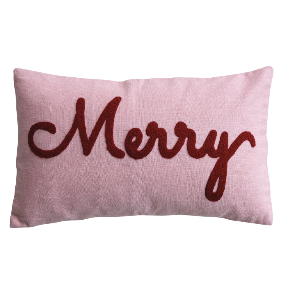 A rectangular light pink throw pillow featuring the word 'Merry' in dark red cursive embroidery, set against a plain white background.