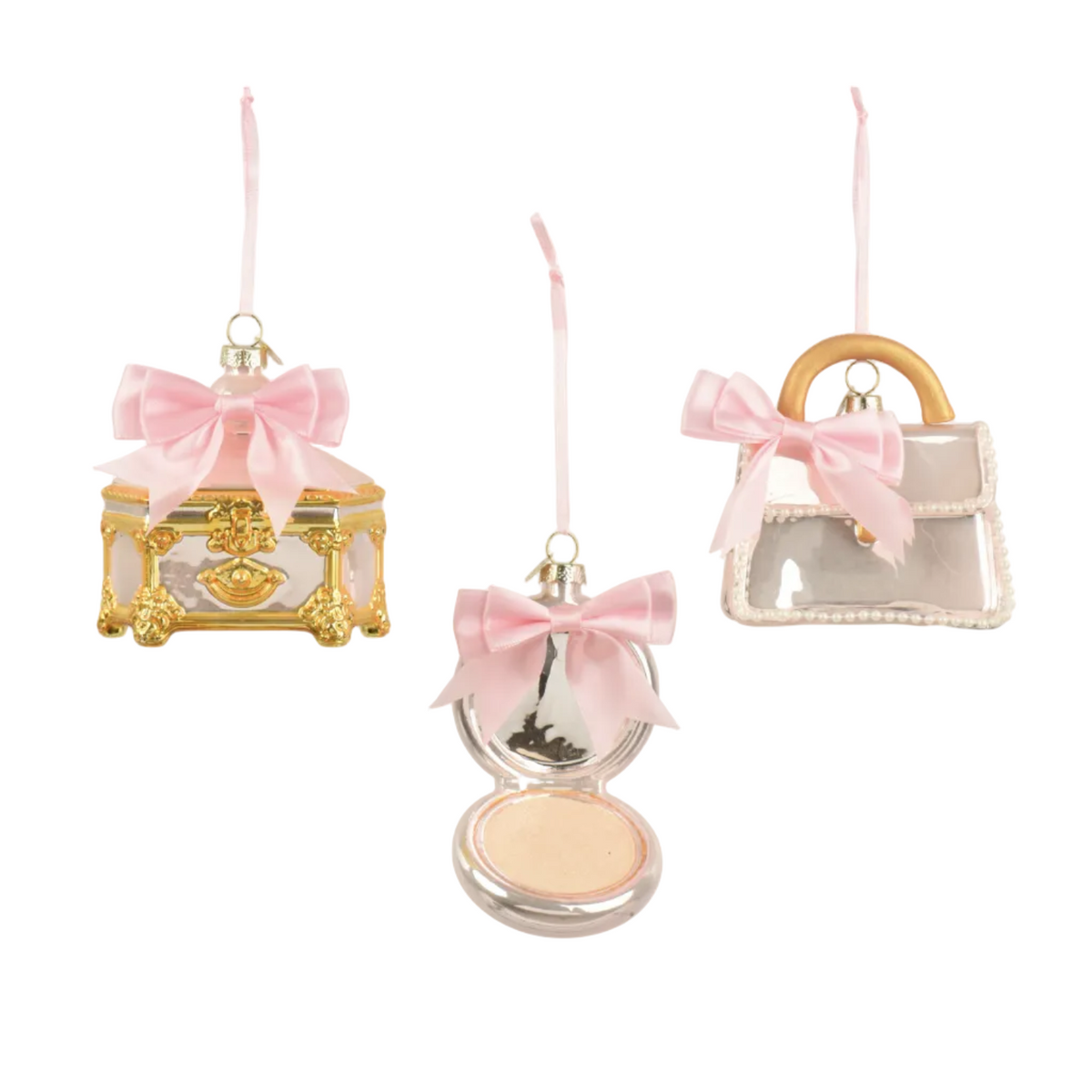 Three decorative hanging ornaments shaped like a gold jewelry box, an open compact mirror with pink powder, and a clear handbag with a pink bow, shown on a white background.