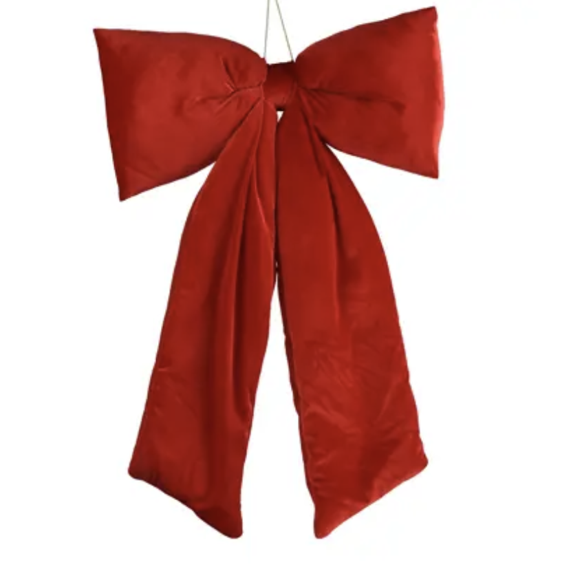 A large red satin bow with long tails, suspended by a thin string against a plain white background.
