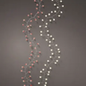 Two strands of delicate Christmas-style string lights with small round bulbs, one glowing red and the other glowing white, arranged in vertical wavy lines against a dark gray background.