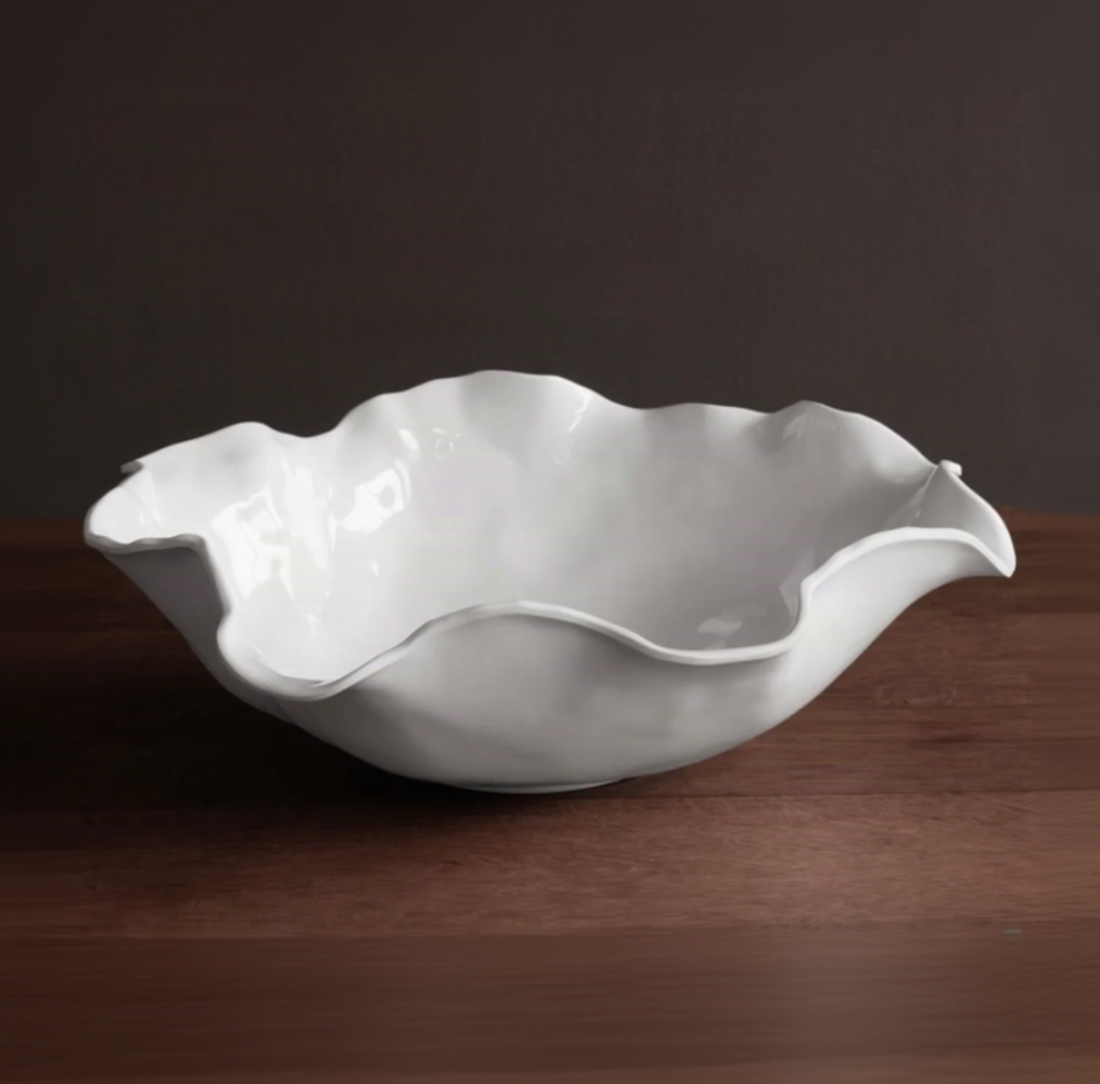 White ceramic shell-shaped bowl on a dark background