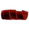 A roll of deep red velvet ribbon, partially unrolled to show its soft, plush texture, set against a plain white background.