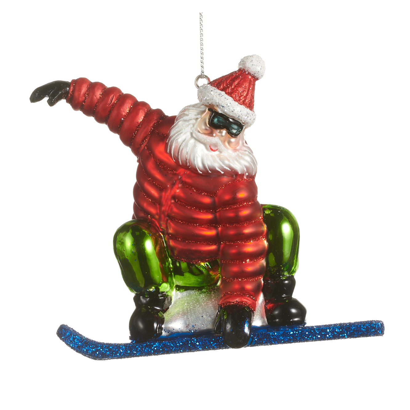 A Santa Claus snowboard ornament featuring a glittery red jacket, green pants, black boots, a red Santa hat with a white pom-pom, and a blue glittery snowboard, shown against a plain white background.