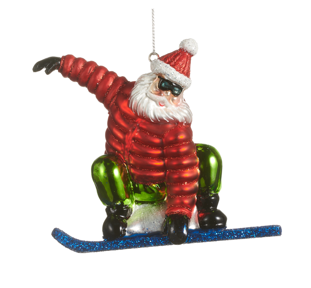 A Santa Claus snowboard ornament featuring a glittery red jacket, green pants, black boots, a red Santa hat with a white pom-pom, and a blue glittery snowboard, shown against a plain white background.