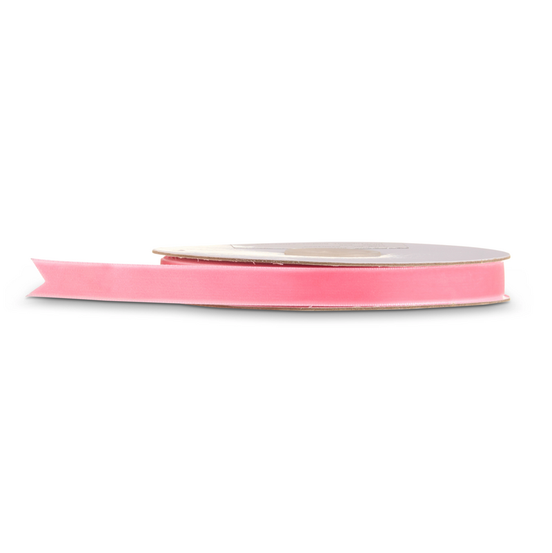 A roll of bright pink ribbon on a clean white background.
