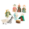 A set of small felt nativity figurines on a plain white background, including stylized human characters in colorful robes and two animals, a white sheep and a gray donkey, with a small hay bale.