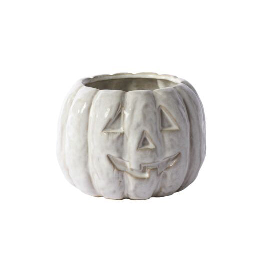 White ceramic pumpkin with jack-o'-lantern face on a white background