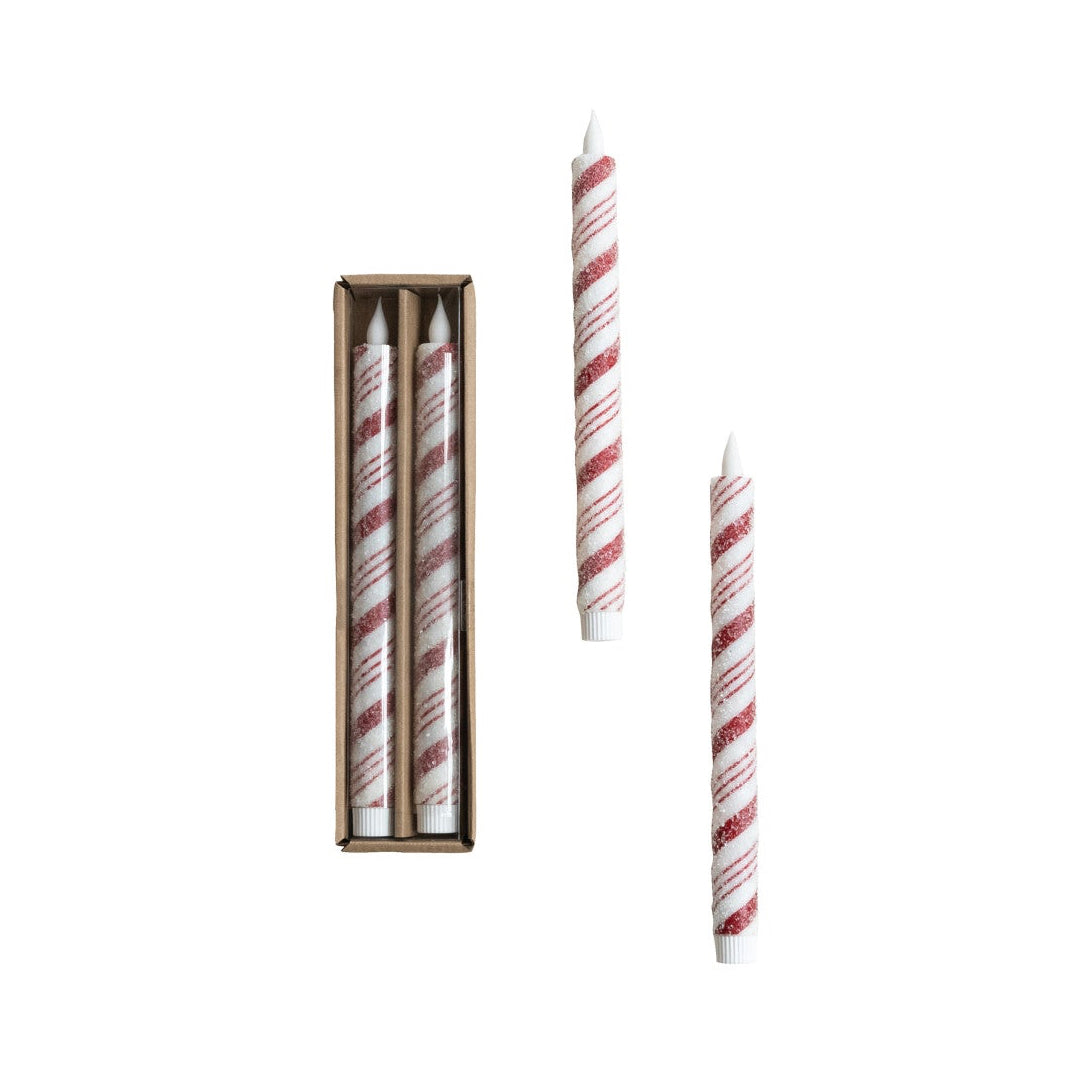 Set of red and white striped candles with a box on a white background