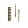 Three striped taper candles with alternating cream and metallic gold bands, shown with two candles standing upright and one set of three in a brown rectangular gift box on a white background.